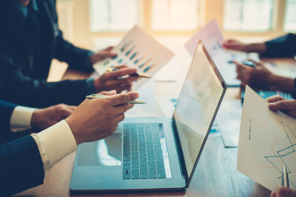 istock Business people brainstorm, discuss, plan and analyze business investment data graphs in meeting room. 1404136040