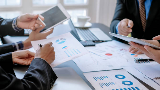 istock Business people brainstorm, discuss, plan and analyze business investment data graphs in meeting room. 1404136856