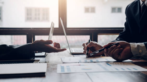 istock Business people brainstorm, discuss, plan and analyze business investment data graphs in meeting room. 1404136873