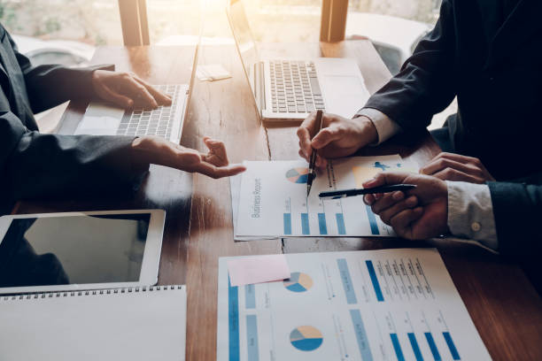 istock Business people brainstorm, discuss, plan and analyze business investment data graphs in meeting room. 1404136885