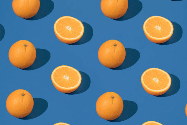 istock Trendy pattern with fresh orange on a blue background. Minimal summer wallpaper. 1404139235