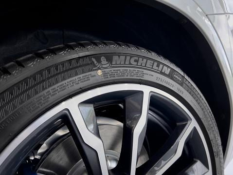 Toronto, ON, Canada - June 11, 2022: Close up of a brand new Michelin tire mounted on alloy rim on a white car.  Michelin is a multinational tire manufacture based in Clermont-Ferrand, France.
