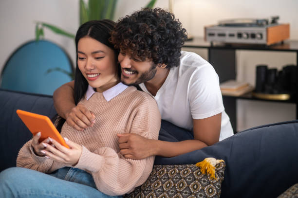istock Young cute couple having a video call and looking involved 1404142062