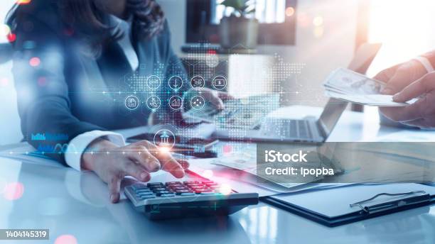 Woman Accountant Use Calculator To Calculate The Companys Financial Results With Icon Banking On Data Network Connection Of Finance And Banking And Analytical Research Income Tax And Business Growth Stock Photo - Download Image Now