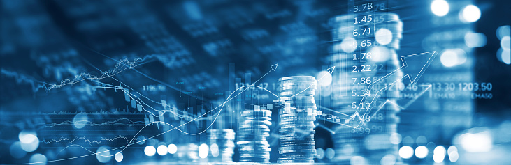 Finance and business concept. Investment graph and rows growth of coins on display of market quotes, stock market and data, rate exchange, blue color tone.