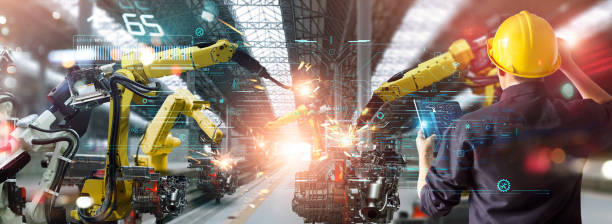 istock Engineer check and control welding robotics automatic arms machine in intelligent factory automotive industrial with monitoring system software. Digital manufacturing operation. Industry 4.0 1404145530