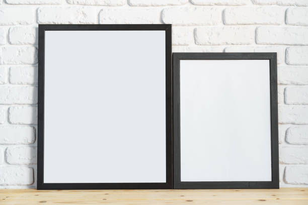 istock Photo frames on floor over white brick wall 1404147058