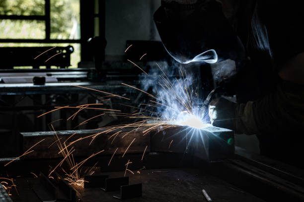 istock Steel worker grinding metal in a workshop. 1404148673