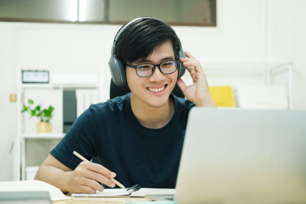 istock Young man study in front of the laptop computer at home 1404149446