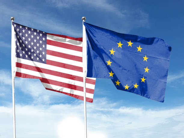 istock USA and EU flags with blue sky. waving blue sky 1404149531