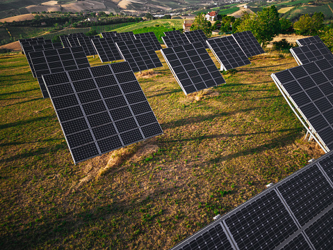 Beautiful italian countryside with a green solar energy field up on the hills of central Italy coastline.