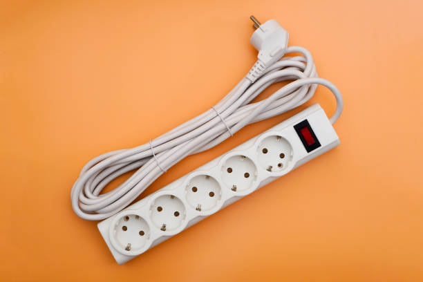 Top view on power strip with neatly coiled electrical cord