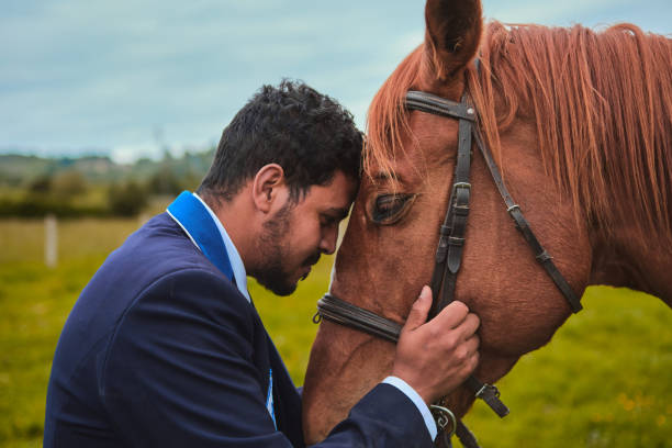 istock Dark-haired boy hugging his horse after a ride 1404150654