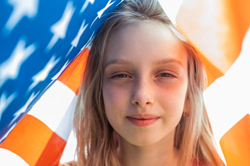 Girl with american flag. Fourth of July concept.
