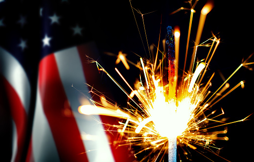 Close-Up Sparkler And USA Flag On Black Background. 4th Of July Concept.