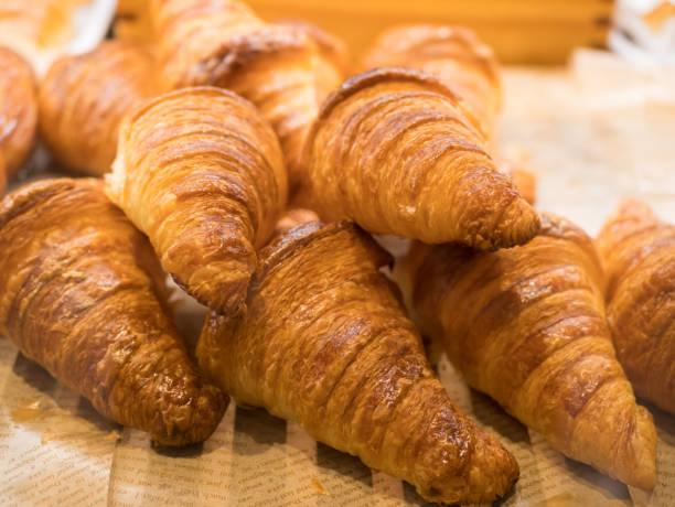 Tasty croissants on the tray sellin in the bakery shop. stock photo