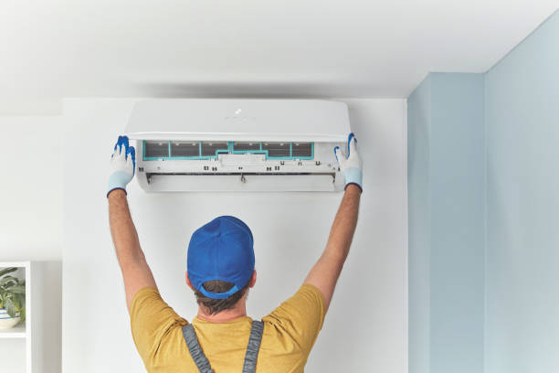istock Repairman cleaning and fixing indoors AC unit. 1404156834