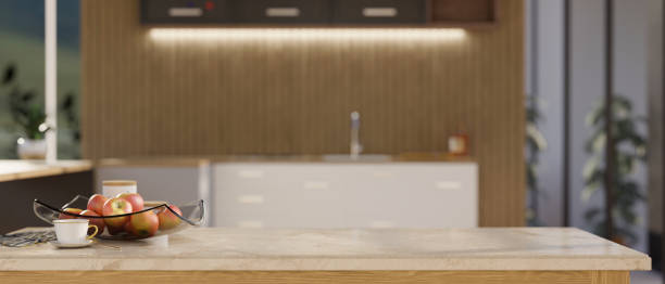 istock Modern marble kitchen tabletop with copy space over blurred luxury kitchen interior in the background. 1404156875