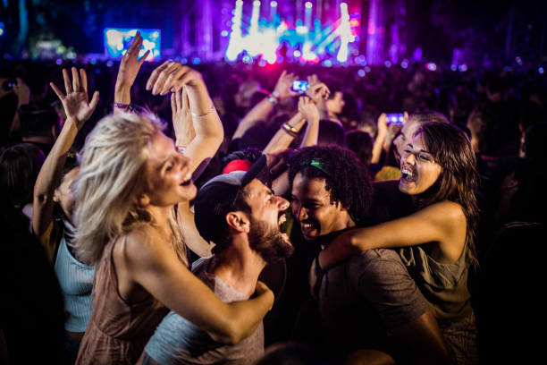istock Carefree couples having fun while dancing on music festival. 1404157006