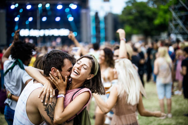 istock Embraced couple having fun on music concert. 1404157101
