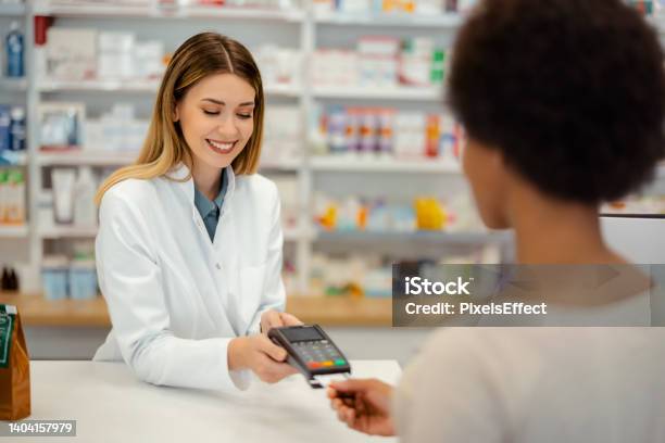 Accepting Payment For A Healthcare Purchase Stock Photo - Download Image Now - Paying, Doctor, Credit Card