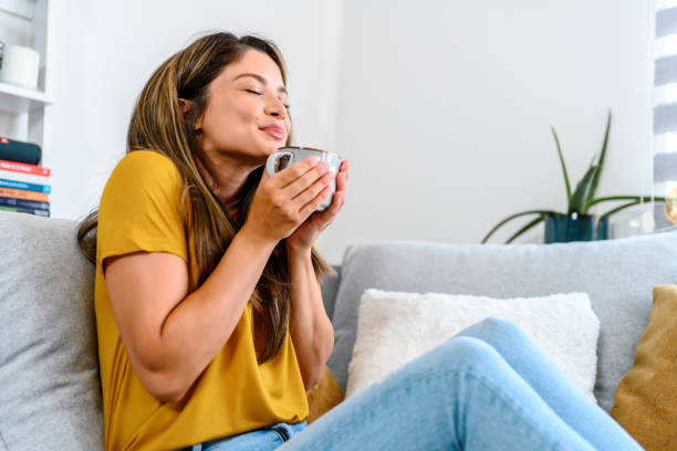 istock Woman relaxing at home drinking coffee 1404158756