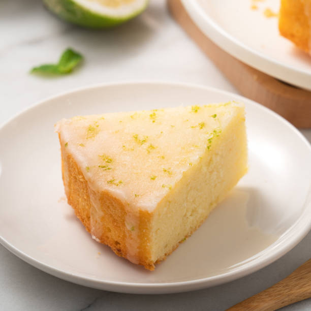 istock Delicious Lemon Glazed Pound Sponge cake on white marble table background. 1404159545