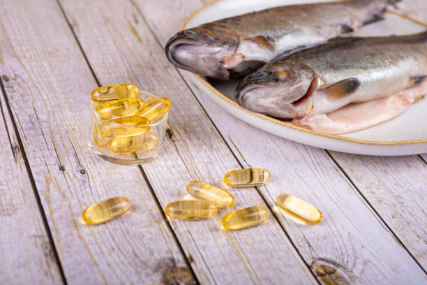 istock Food supplement capsules with oil - omega 3, vitamin A or E - with fish 1404159657
