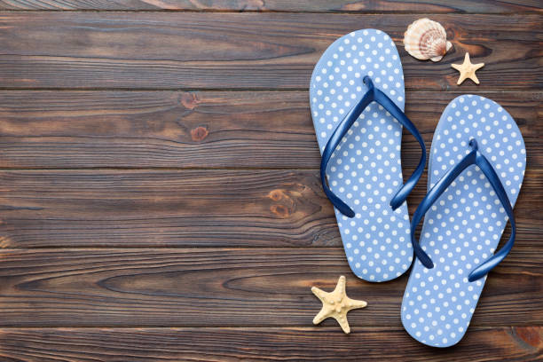 istock Flat lay composition with flip flops and seashell on colored background. Space for text top view 1404160257