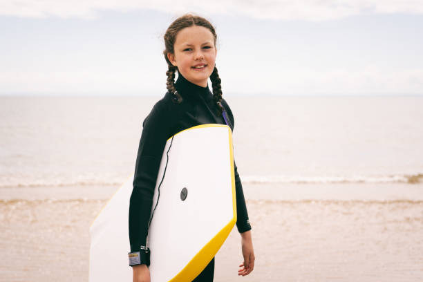 istock Young Girl Bodyboarding Vacation 1404160988