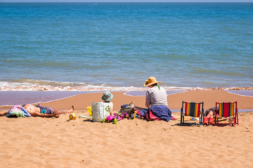 Kent, England - 14 June, 2022 - family enjoying sunshine on the sandy beach at Stone Bay in the seaside town of Broadstairs