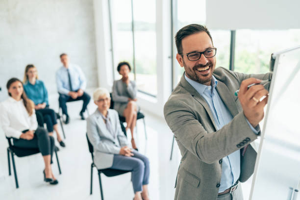 istock Happy male leader writing a business plan on whiteboard 1404162987