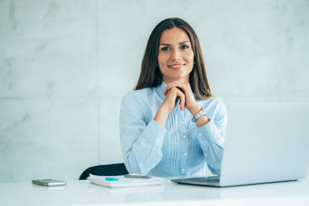 Portrait of confident businesswoman at workplace stock photo