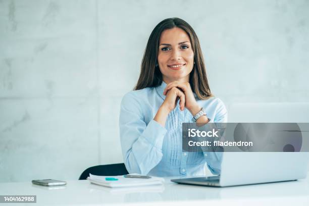 Portrait Of Confident Businesswoman At Workplace Stock Photo - Download Image Now - Bank Manager, Desk, Women