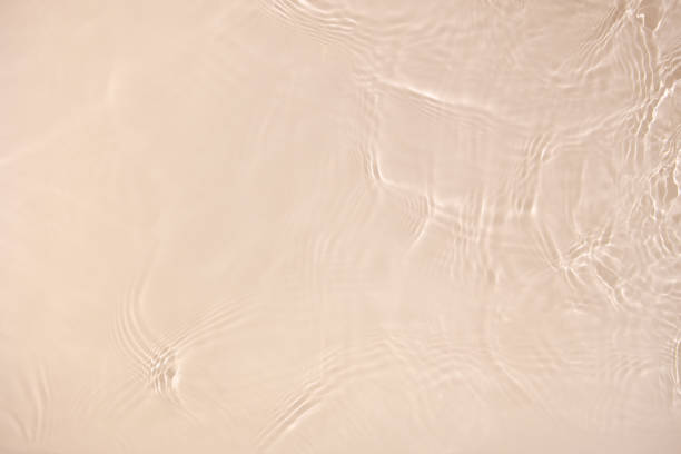 istock transparent beige colored clear calm water surface texture 1404166820