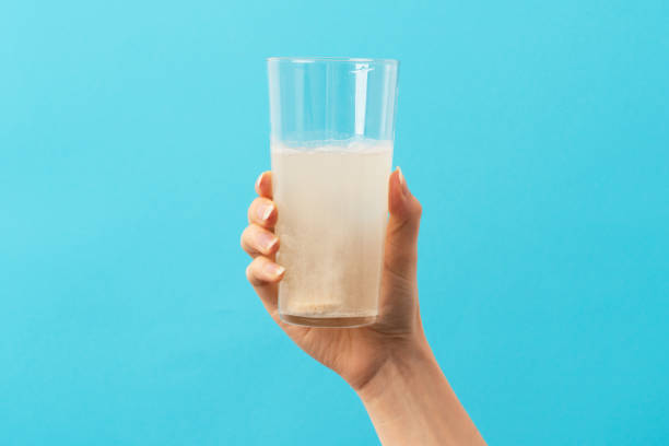istock A glass with effervescent tablet on the blue and green background 1404167293