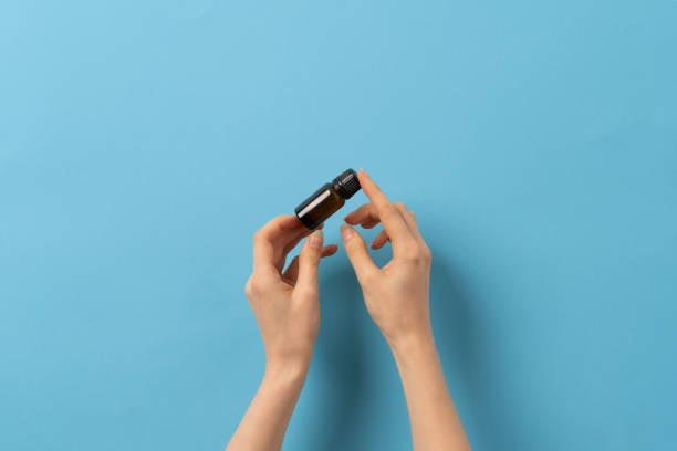 istock Female hand holding a jar of medication liquid 1404168413