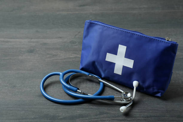 istock First aid medical kit on dark wooden background 1404168897