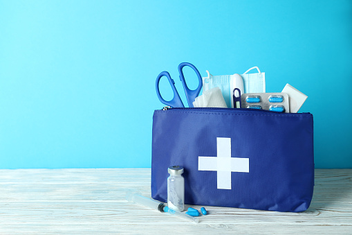 First aid medical kit against blue background