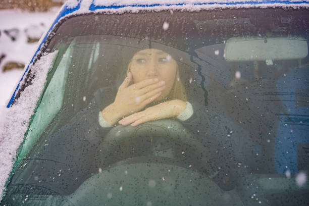 istock Woman in a car during a snowfall, problems on the road 1404171423