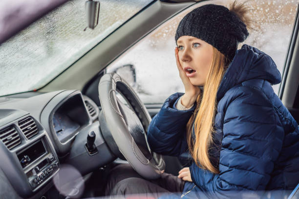 istock Woman in a car during a snowfall, problems on the road 1404171427