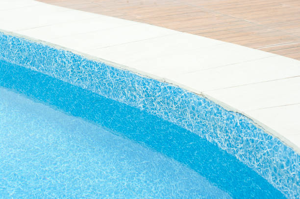 istock Swimming pool with clean blue water under the bright sunlight. 1404171883