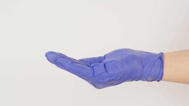 istock Empty hand wear violet latex glove doing sign for help on white background. side view 1404172198
