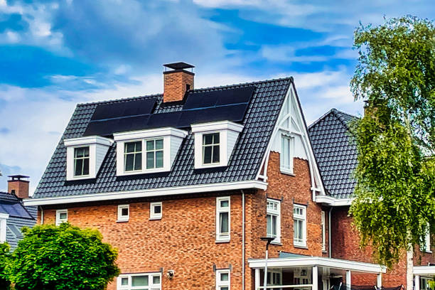 house with solar panels on roof stock photo