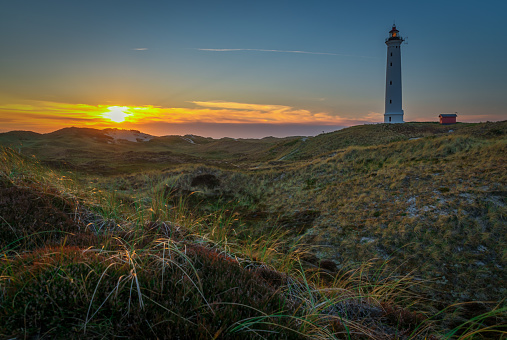 Beautiful sunset behind the white lighthouse Lyngvid in Denmark.