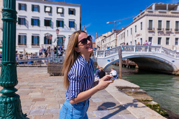 Female tourist using phone on the street.