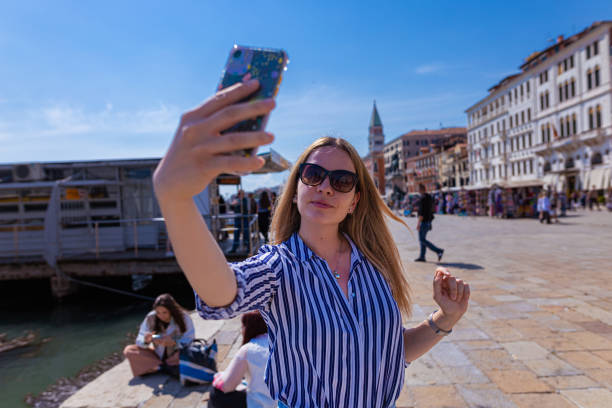 istock Happy woman tourist taking selfies 1404175456
