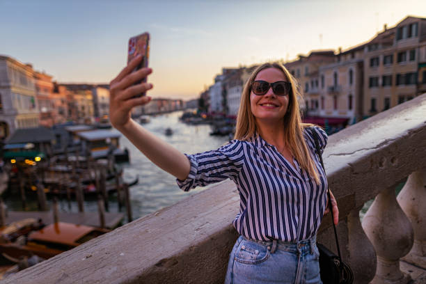 istock Cheerful young woman taking selfie 1404175497