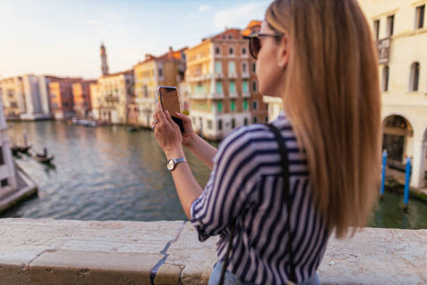istock Young woman photographing Venice 1404175518