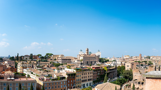 Panorama view of the city of Rome on a beautiful sunny day. Cityscape with architecture, church towers and old buildings.